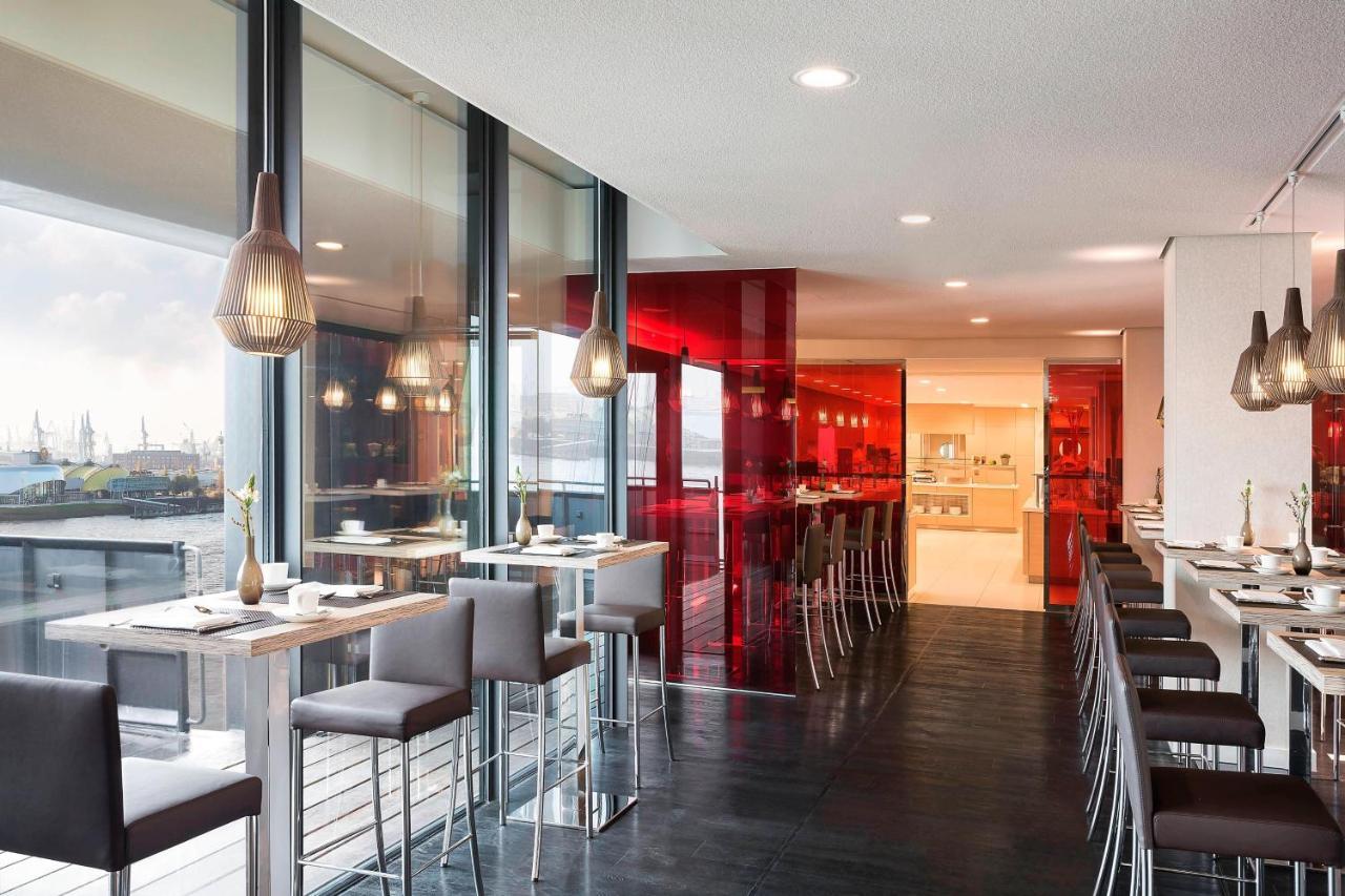The Westin Hamburg Elbphilharmonie Hotell Eksteriør bilde The photo showcases a modern restaurant interior characterized by sleek design and contemporary decor. The space features a combination of large windows allowing natural light to filter in, creating an open and airy atmosphere. The walls are accented